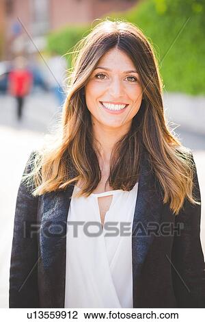 Portrait of happy young woman with long brown hair View Large Photo Image Stock Image - Portrait of happy young woman with long brown hair. Fotosearch