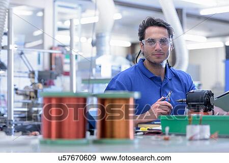 Portrait of male worker in electronics factory View Large Photo Image Stock Photo - Portrait of male worker in electronics factory. Fotosearch