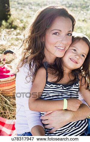 Portrait of mature woman and daughter at park picnic View Large Photo Image Stock Photo - Portrait of mature woman and daughter at park picnic. Fotosearch