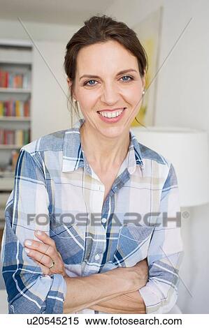 Portrait of mature woman arms folded looking at camera smiling View Large Photo Image Stock Photography - Portrait of mature woman arms folded looking at camera smiling. Fotosearch