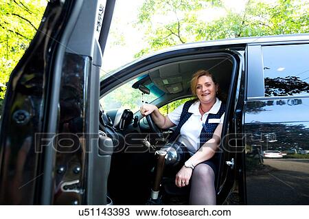 Portrait of mid adult woman with prosthetic leg, sitting in car View Large Photo Image Stock Image - Portrait of mid adult woman with prosthetic leg, sitting in car. Fotosearch