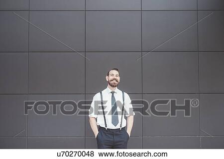 Portrait of stylish businessman with hands in pockets outside office View Large Photo Image Stock Photo - Portrait of stylish businessman with hands in pockets outside office. Fotosearch