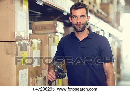 Stock Photography - Portrait of warehouse worker using barcode scanner in distribution warehouse. Fotosearch