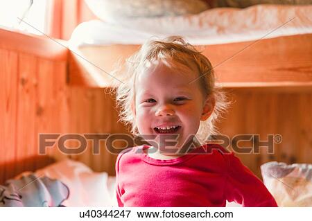 Stock Photo - Portrait of young girl, smiling. Fotosearch
