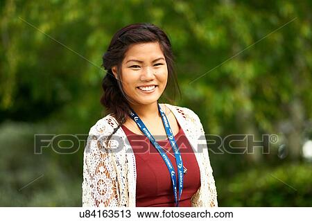 Portrait of young woman, outdoors View Large Photo Image Stock Image - Portrait of young woman, outdoors. Fotosearch