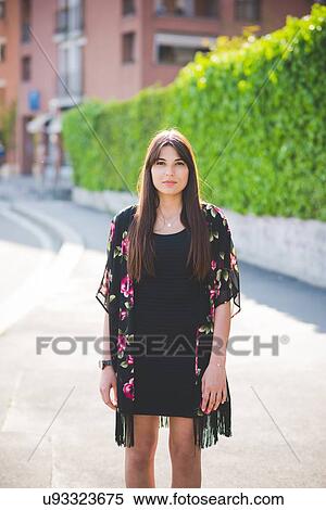 Portrait of young woman with long brown hair View Large Photo Image Stock Photography - Portrait of young woman with long brown hair. Fotosearch