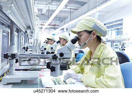 Picture - Quality check station at factory producing flexible electronic circuit boards. Plant is located in the south of China, in Zhuhai, Guangdong province. Fotosearch