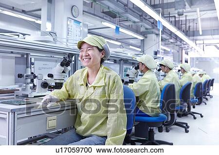 Stock Image - Quality check station at factory producing flexible electronic circuit boards. Plant is located in the south of China, in Zhuhai, Guangdong province. Fotosearch