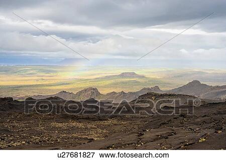 Rainbow and clouds over volcanic landscape, Helgafell, Iceland View Large Photo Image Stock Photo - Rainbow and clouds over volcanic landscape, Helgafell, Iceland. Fotosearch