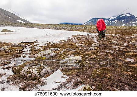 Rear view of young man hiking in frozen landscape, Ural mountains, Russia View Large Photo Image Stock Image - Rear view of young man hiking in frozen landscape, Ural mountains, Russia. Fotosearch