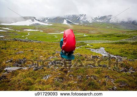 Rear view of young man hiking in valley, Ural mountains, Russia View Large Photo Image Stock Image - Rear view of young man hiking in valley, Ural mountains, Russia. Fotosearch