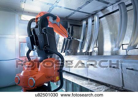 Stock Image - Robot spray painting automotive parts in spray paint factory. Fotosearch