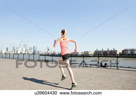 Runner jogging along waterfront, Wapping, London View Large Photo Image Stock Image - Runner jogging along waterfront, Wapping, London. Fotosearch