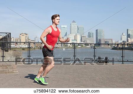 Runner jogging along waterfront, Wapping, London View Large Photo Image Stock Image - Runner jogging along waterfront, Wapping, London. Fotosearch