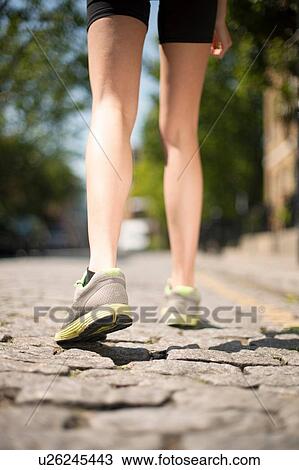 Runner jogging on cobbled street View Large Photo Image Stock Image - Runner jogging on cobbled street. Fotosearch