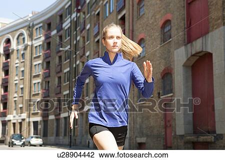 Runner jogging past building block, Wapping, London View Large Photo Image Stock Image - Runner jogging past building block, Wapping, London. Fotosearch