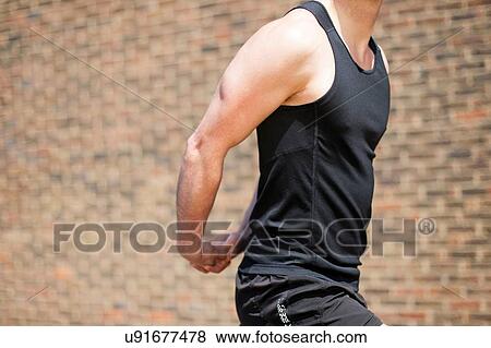 Runner stretching by brick wall View Large Photo Image Stock Photo - Runner stretching by brick wall. Fotosearch
