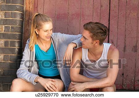 Runners resting in front of building door View Large Photo Image Stock Image - Runners resting in front of building door. Fotosearch