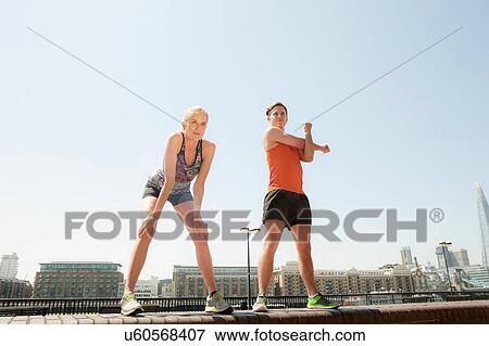 Runners stretching on riverfront, Wapping, London View Large Photo Image Stock Photo - Runners stretching on riverfront, Wapping, London. Fotosearch