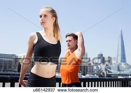 Runners stretching on riverfront, Wapping, London View Large Photo Image Stock Photo - Runners stretching on riverfront, Wapping, London. Fotosearch