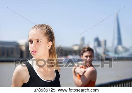 Runners stretching on riverfront, Wapping, London View Large Photo Image Stock Photography - Runners stretching on riverfront, Wapping, London. Fotosearch