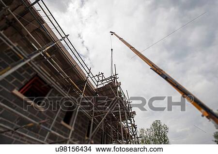 Scaffolding on building of construction site View Large Photo Image Picture - Scaffolding on building of construction site. Fotosearch