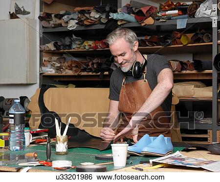 Shoemaker at work View Large Photo Image Stock Photograph - Shoemaker at work. Fotosearch