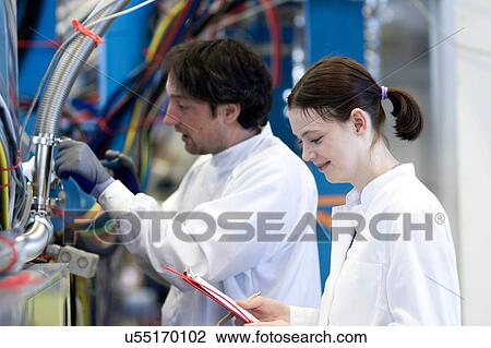 side view of male and female colleagues wearing lab coats, holding clipboard View Large Photo Image Stock Image - side view of male and female colleagues wearing lab coats, holding clipboard. Fotosearch