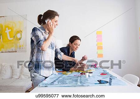 Side view of mature women using smartphone and looking at digital tablet View Large Photo Image Stock Photo - Side view of mature women using smartphone and looking at digital tablet. Fotosearch