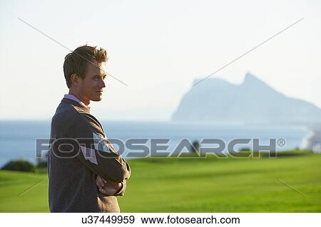 Side view of mid adult man waist up arms folded looking away View Large Photo Image Stock Photo - Side view of mid adult man waist up arms folded looking away. Fotosearch