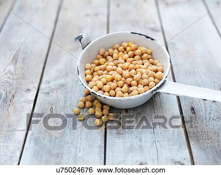Still life of chick peas (also known as gram, bengal gram, garbanzo, garbanzo bean and Egyptian pea) in enamel saucepan View Large Photo Image Stock Photograph - Still life of chick peas (also known as gram, bengal gram, garbanzo, garbanzo bean and Egyptian pea) in enamel saucepan. Fotosearch
