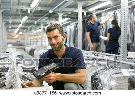 Stock Photograph - Stock take in warehouse. Fotosearch