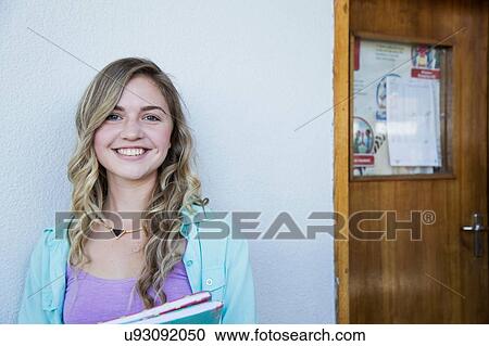 Stock Image - Student outside classroom. Fotosearch