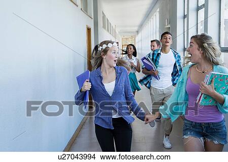 Students running down hallway, laughing View Large Photo Image Picture - Students running down hallway, laughing. Fotosearch