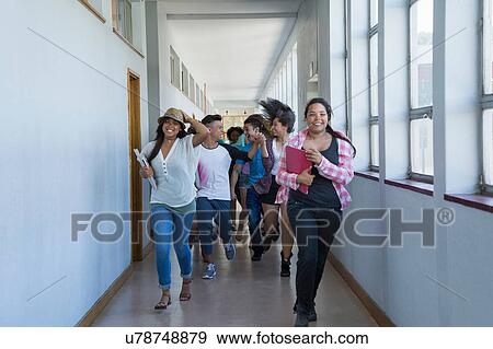 Stock Photo - Students running down hallway, laughing. Fotosearch