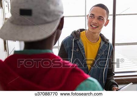 Students standing beside lockers, chatting View Large Photo Image Stock Image - Students standing beside lockers, chatting. Fotosearch