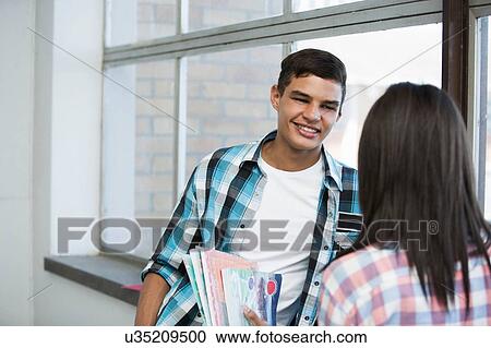 Students standing by window, chatting View Large Photo Image Stock Image - Students standing by window, chatting. Fotosearch