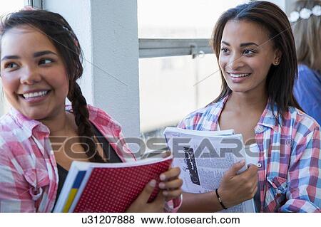 Students standing by window, chatting View Large Photo Image Stock Photo - Students standing by window, chatting. Fotosearch