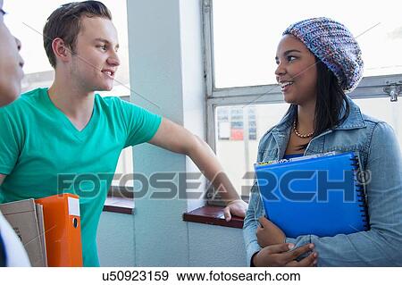 Students standing by window, chatting View Large Photo Image Stock Photo - Students standing by window, chatting. Fotosearch