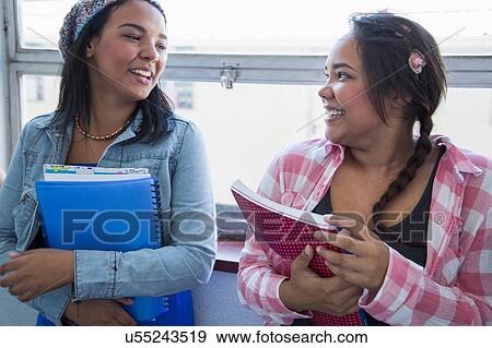 Students standing by window, chatting View Large Photo Image Stock Photo - Students standing by window, chatting. Fotosearch