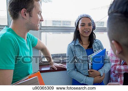 Students standing by window, chatting View Large Photo Image Stock Photo - Students standing by window, chatting. Fotosearch