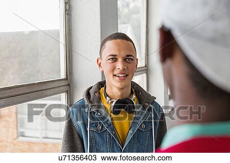 Students standing in hallway, chatting View Large Photo Image Stock Image - Students standing in hallway, chatting. Fotosearch
