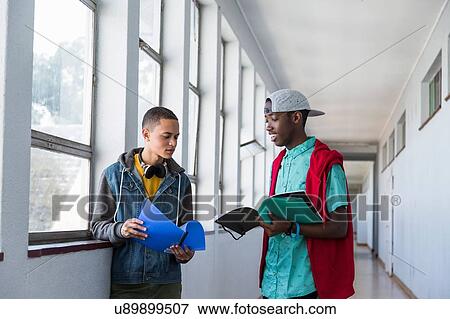 Students standing in hallway, chatting View Large Photo Image Stock Photo - Students standing in hallway, chatting. Fotosearch