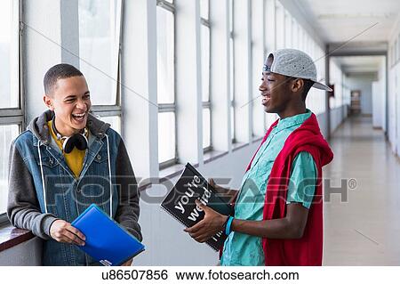 Stock Photograph - Students standing in hallway, chatting. Fotosearch