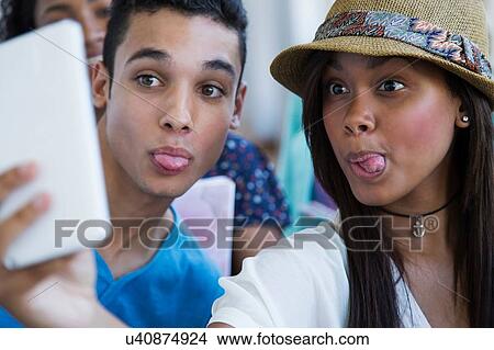 Students standing in hallway, taking selfie View Large Photo Image Picture - Students standing in hallway, taking selfie. Fotosearch