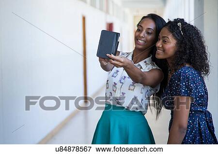 Students standing in hallway, taking selfie View Large Photo Image Stock Photo - Students standing in hallway, taking selfie. Fotosearch
