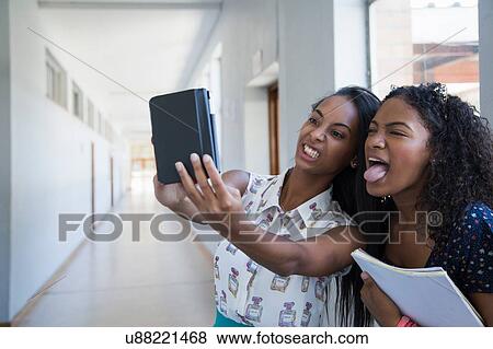Students standing in hallway, taking selfie View Large Photo Image Stock Photo - Students standing in hallway, taking selfie. Fotosearch