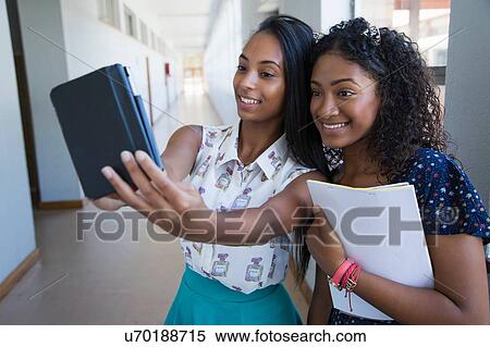 Students standing in hallway, taking selfie View Large Photo Image Stock Photography - Students standing in hallway, taking selfie. Fotosearch