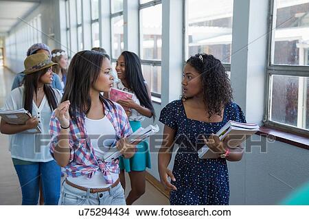 Students walking down hallway, chatting View Large Photo Image Picture - Students walking down hallway, chatting. Fotosearch