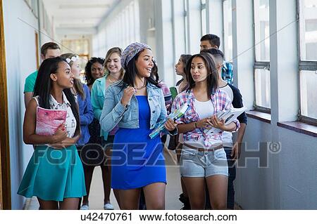 Students walking down hallway, chatting View Large Photo Image Stock Image - Students walking down hallway, chatting. Fotosearch